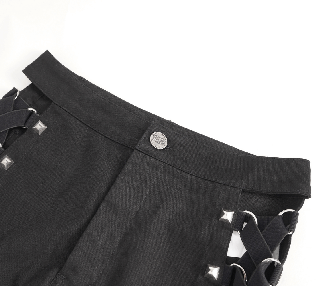 Black rave booty shorts featuring studded detail and adjustable garters for a daring party look.