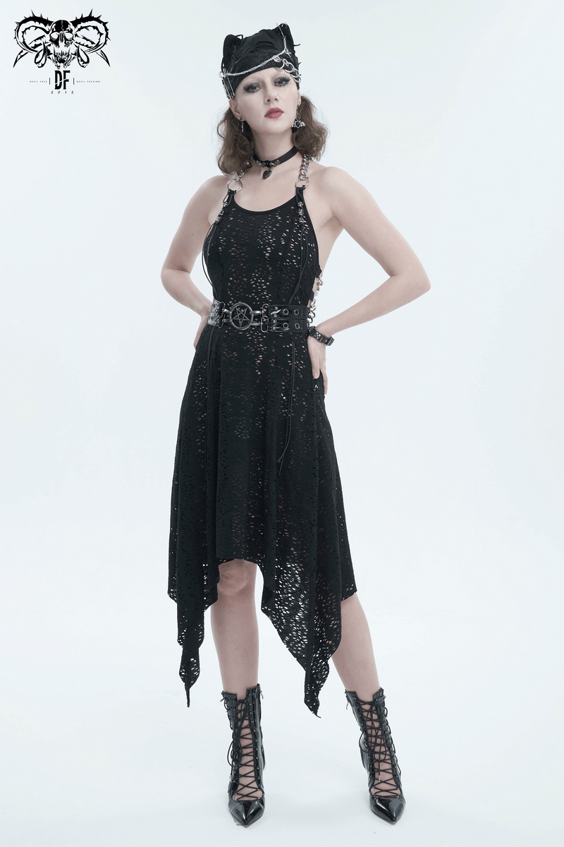 Gothic woman in a black sparkly dress with chains and heels, showcasing edgy punk fashion.