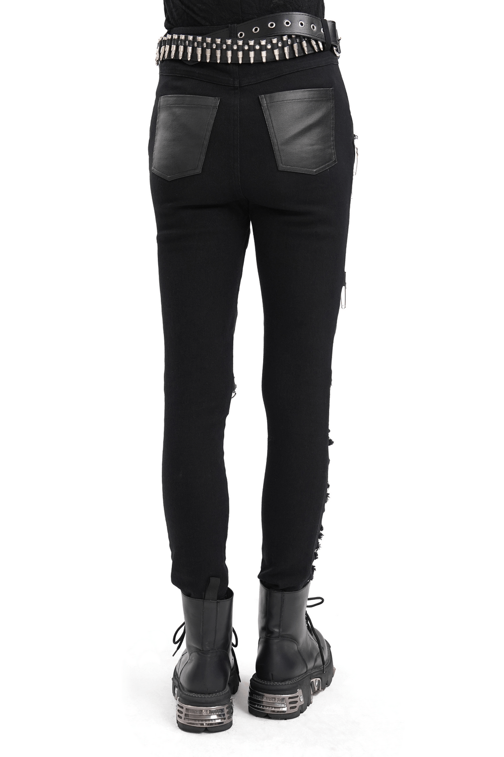 Back view of black ripped skinny jeans with leatherette details and studded belt, perfect for edgy alternative style.