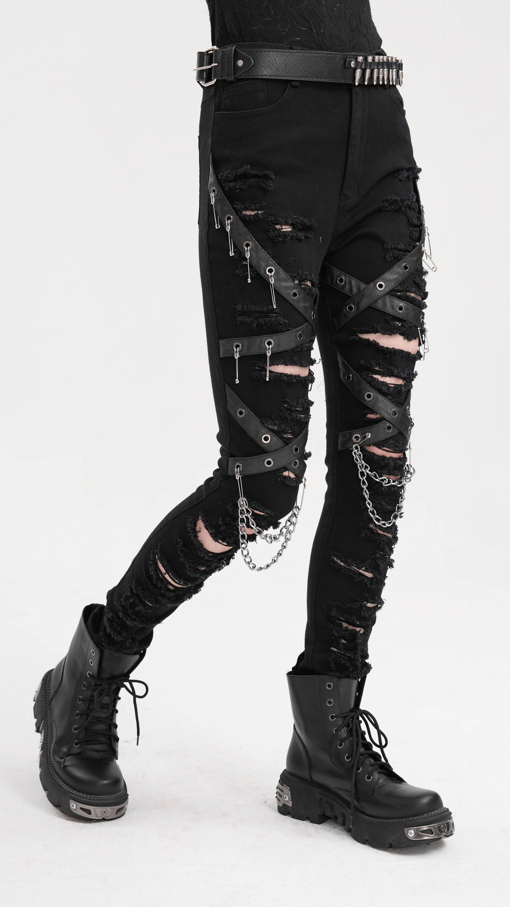 Black ripped skinny jeans with chains and buckles, showcasing an edgy gothic style with distressed details and hardware.