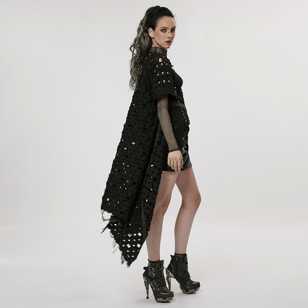 Model wearing a black ripped twill long cardigan-cape with hollow-out design and skull rivets, styled with edgy accessories.