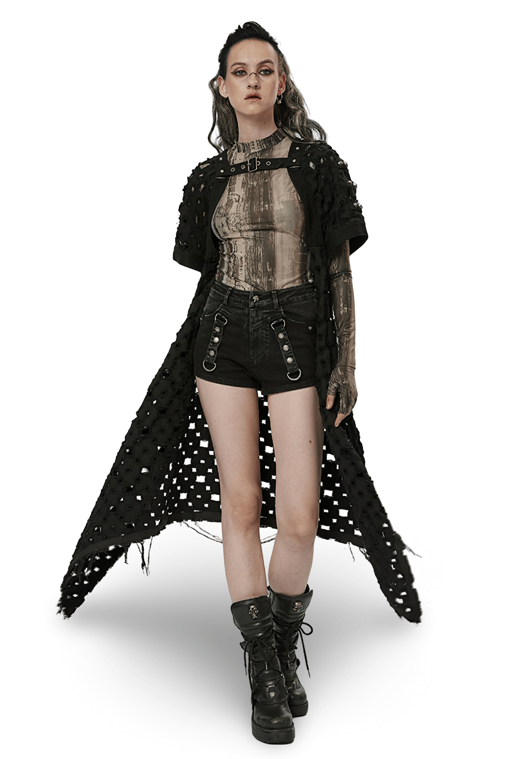 Edgy black ripped long cardigan-cape with skull rivets over a chic outfit, exuding post-apocalyptic style.