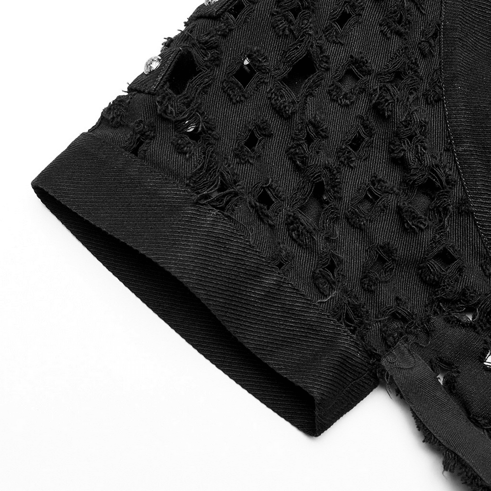 Close-up of black ripped twill cardigan-cape with skull rivets and hollow-out design, showcasing edgy details.