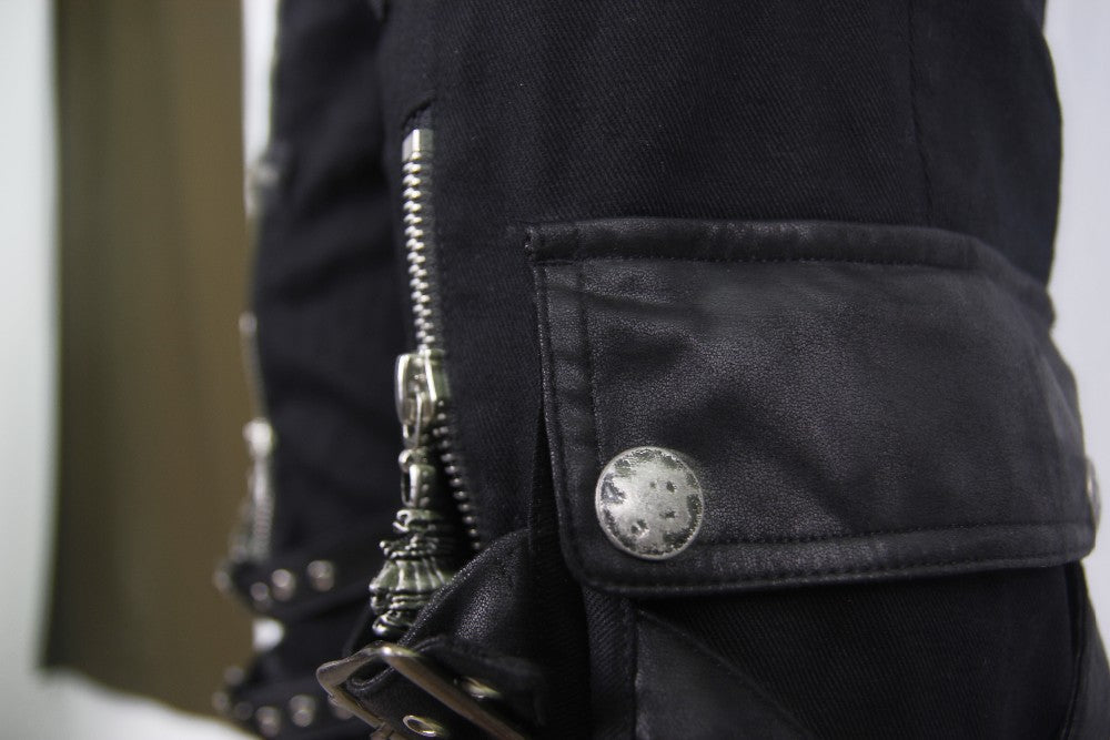 Close-up of black rock shorts featuring zippers and straps, ideal for gothic and alternative fashion enthusiasts.