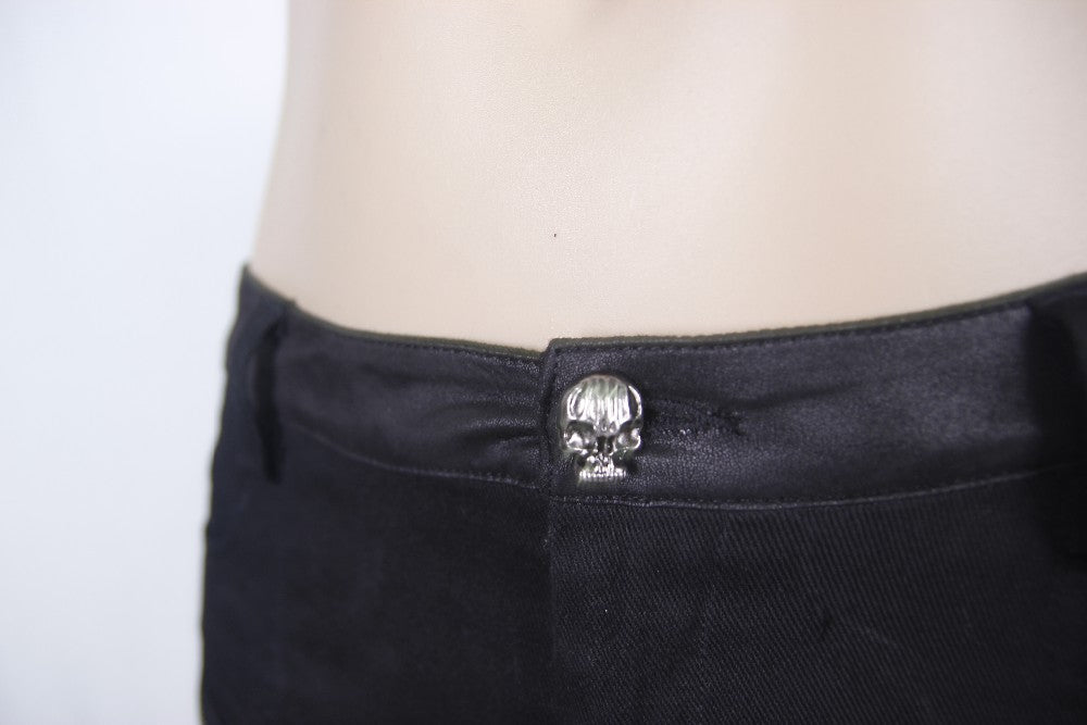 Close-up of black rock style shorts featuring a unique skull button, perfect for gothic fashion.