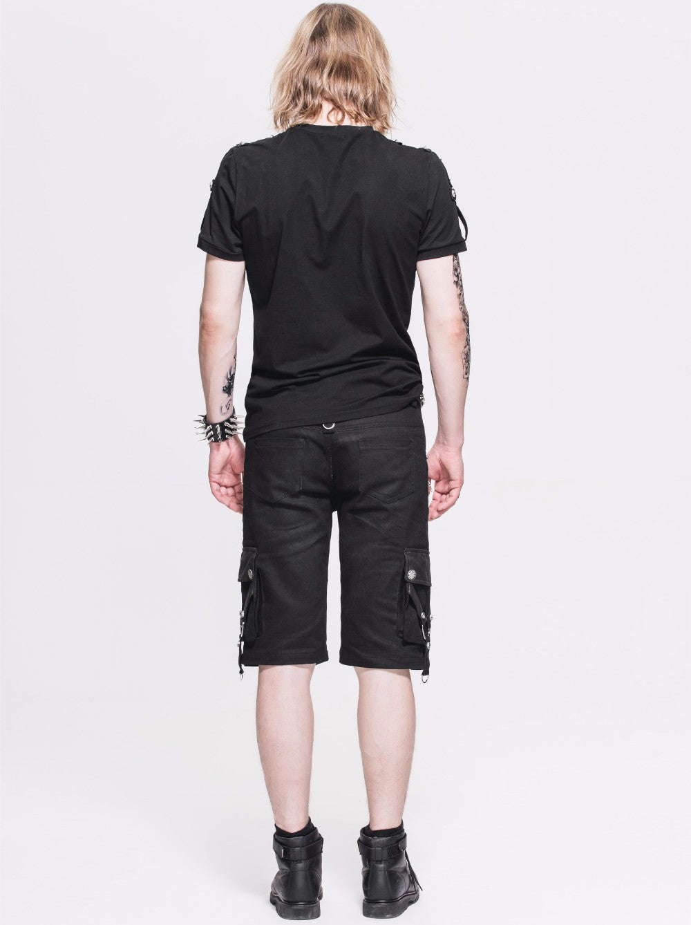 Back view of a man in black rock style shorts with straps and zippers, showcasing alternative fashion.