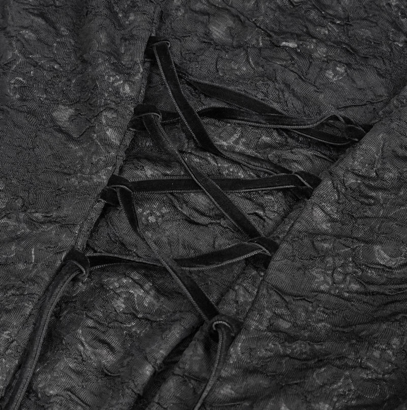 Close-up of black lace detailing with crisscrossed velvet straps, perfect for an elegant gothic dress.