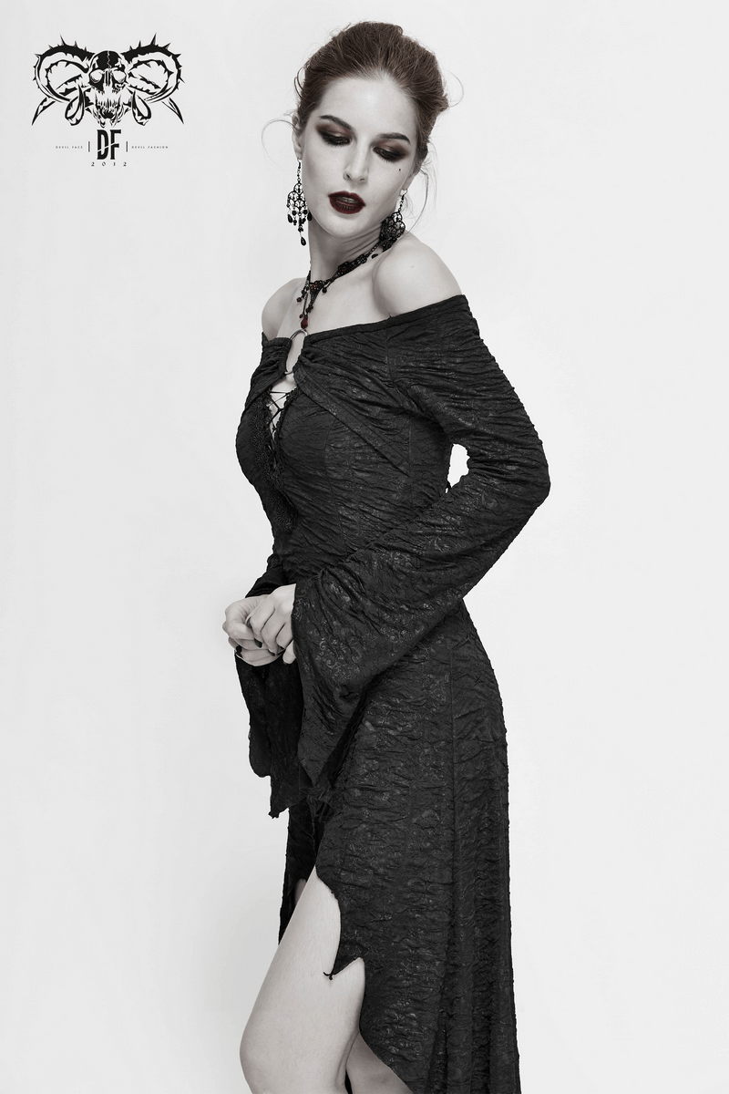Elegant model in a black off-the-shoulder gothic dress with flared sleeves and an asymmetrical hemline.