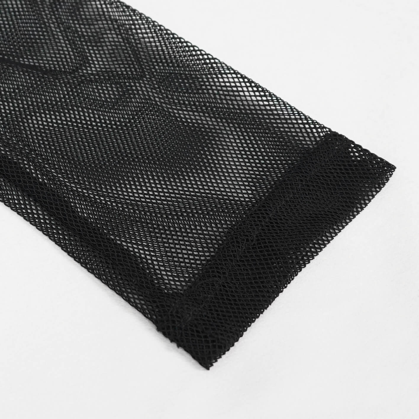 Close-up of black mesh fabric, showcasing a stylish and gothic texture ideal for trendy outfits.