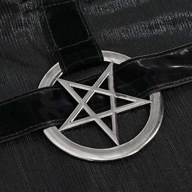 Close-up of a silver pentagram ornament on a black gothic-style dress, showcasing its unique and stylish details.