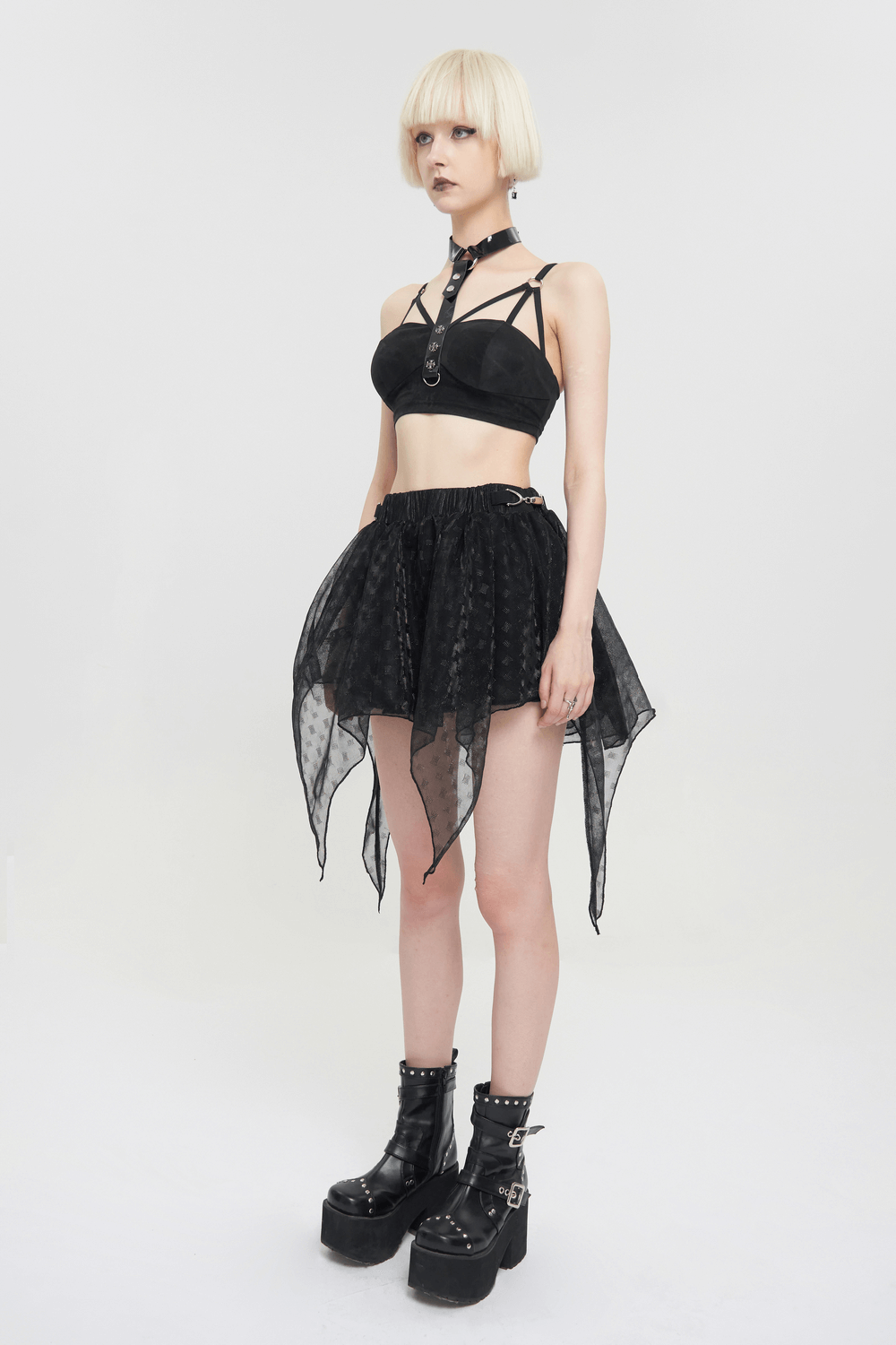 Gothic punk style black bra with faux leather neck strap, paired with a sheer black skirt and chunky platform boots.