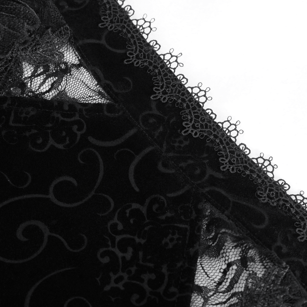 Close-up of black sheer lace crop top showcasing intricate patterns and scalloped edges.