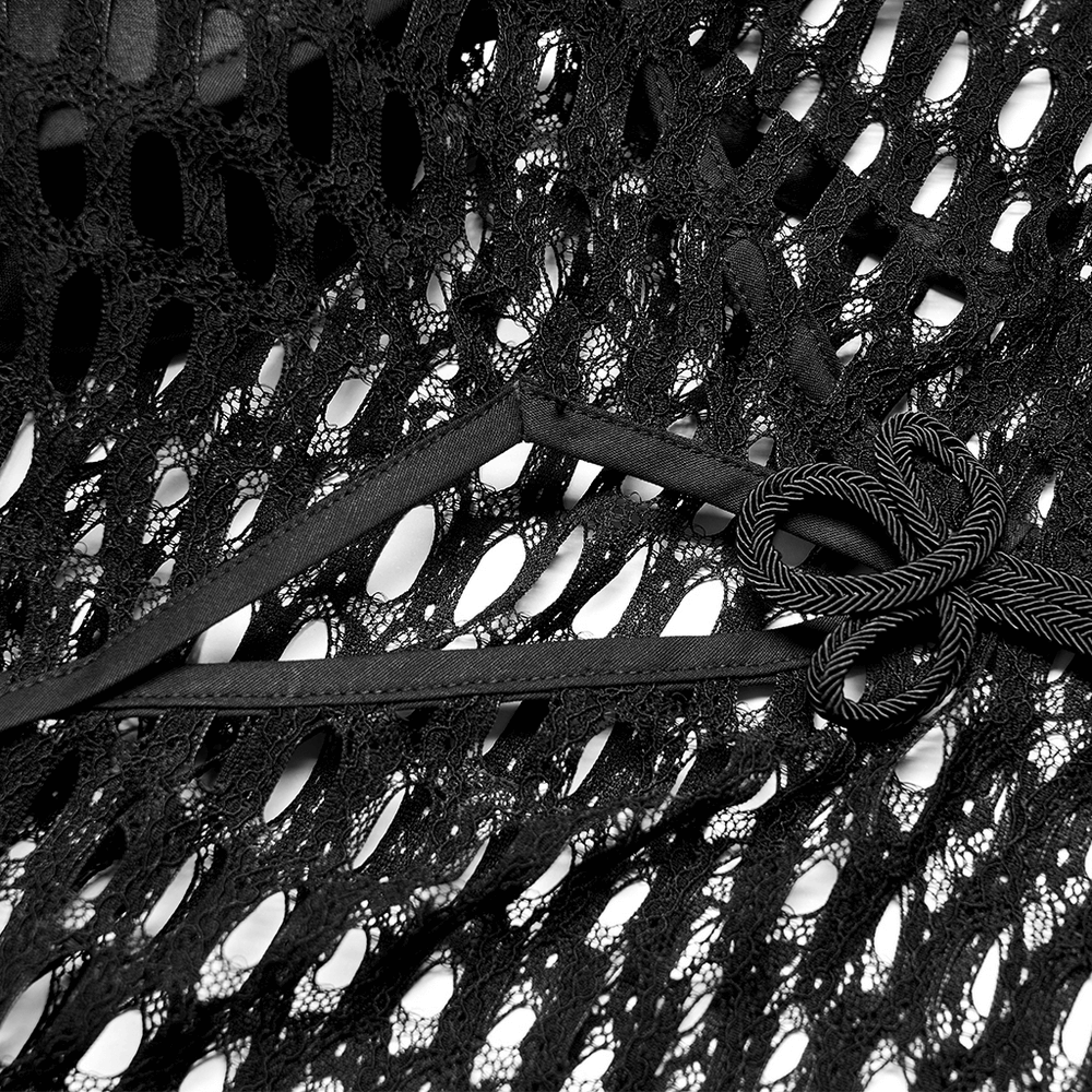 Close-up of black sheer mesh fabric with intricate patterns and bow tie detailing for punk-inspired fashion.