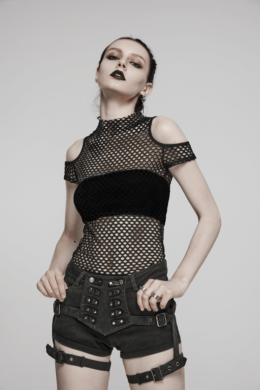 Edgy black sheer off-the-shoulder mesh t-shirt paired with stylish shorts, perfect for an urban chic look.