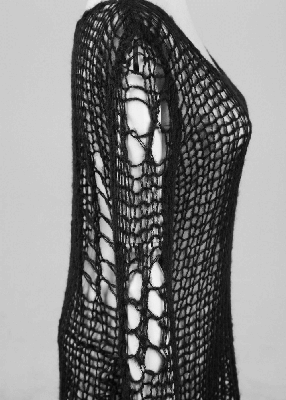 Punk Rave inspired black shredded knit sweater showcasing long sleeves and unique loose-knit design.