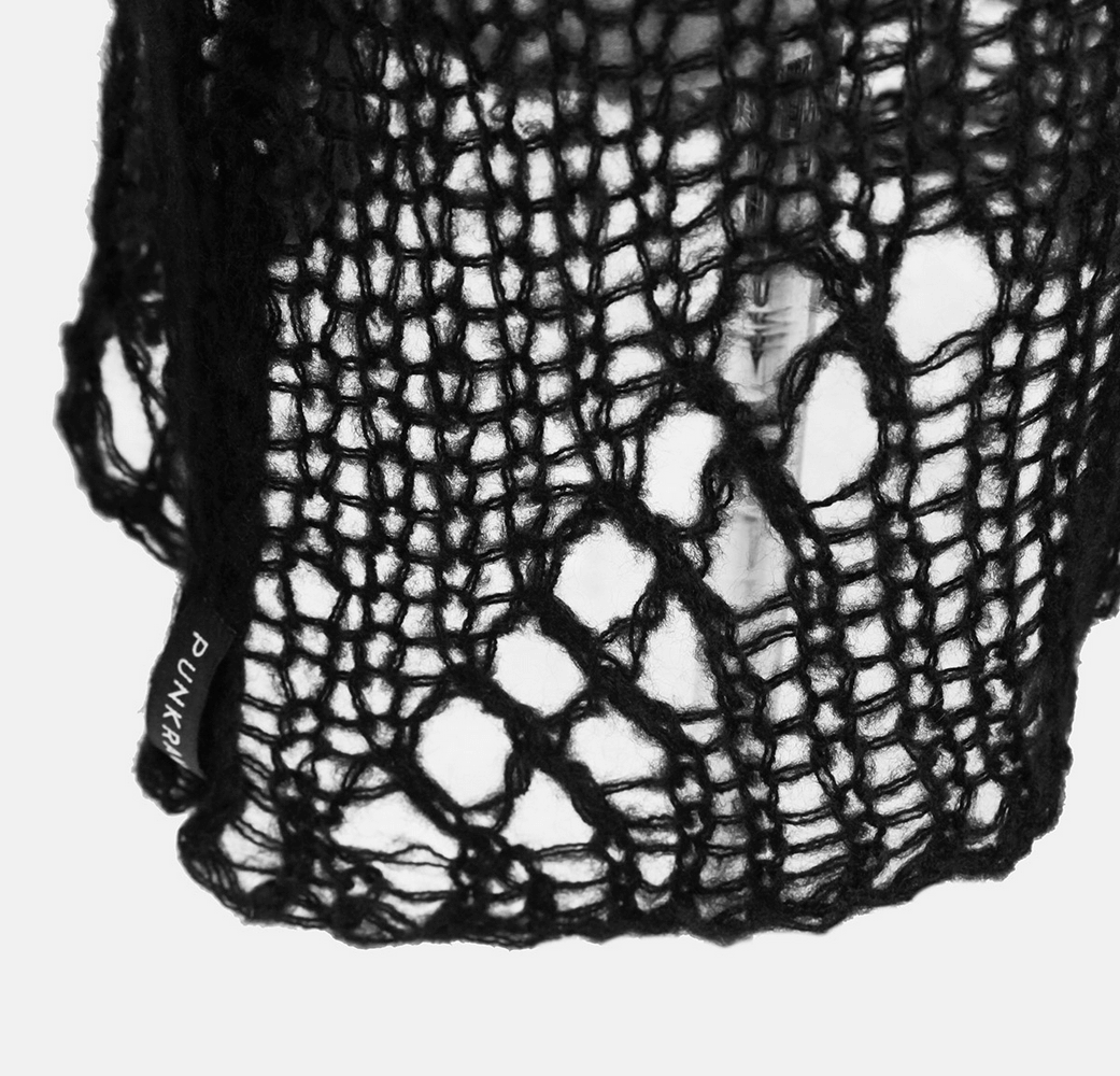 Close-up of black shredded knit crocheted fabric showcasing large holes and Punk Rave tag.