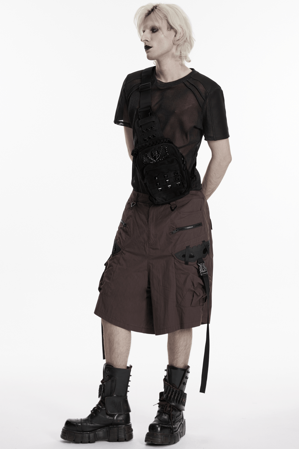 Black Skull Studded Punk Crossbody Backpack Bag worn by a model in punk fashion, showcasing its edgy design and style.