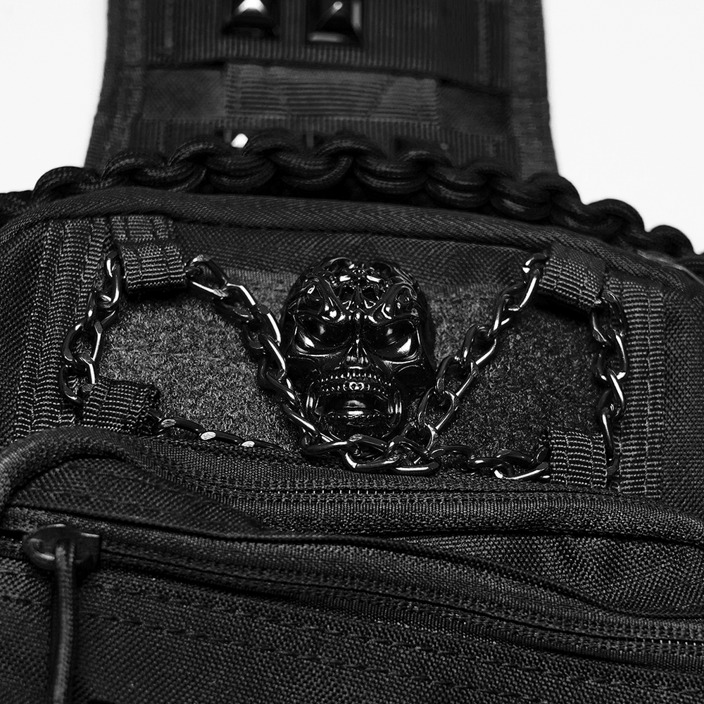Close-up of Black Skull Studded Punk Crossbody Backpack Bag featuring metal skull detail and chain embellishment.