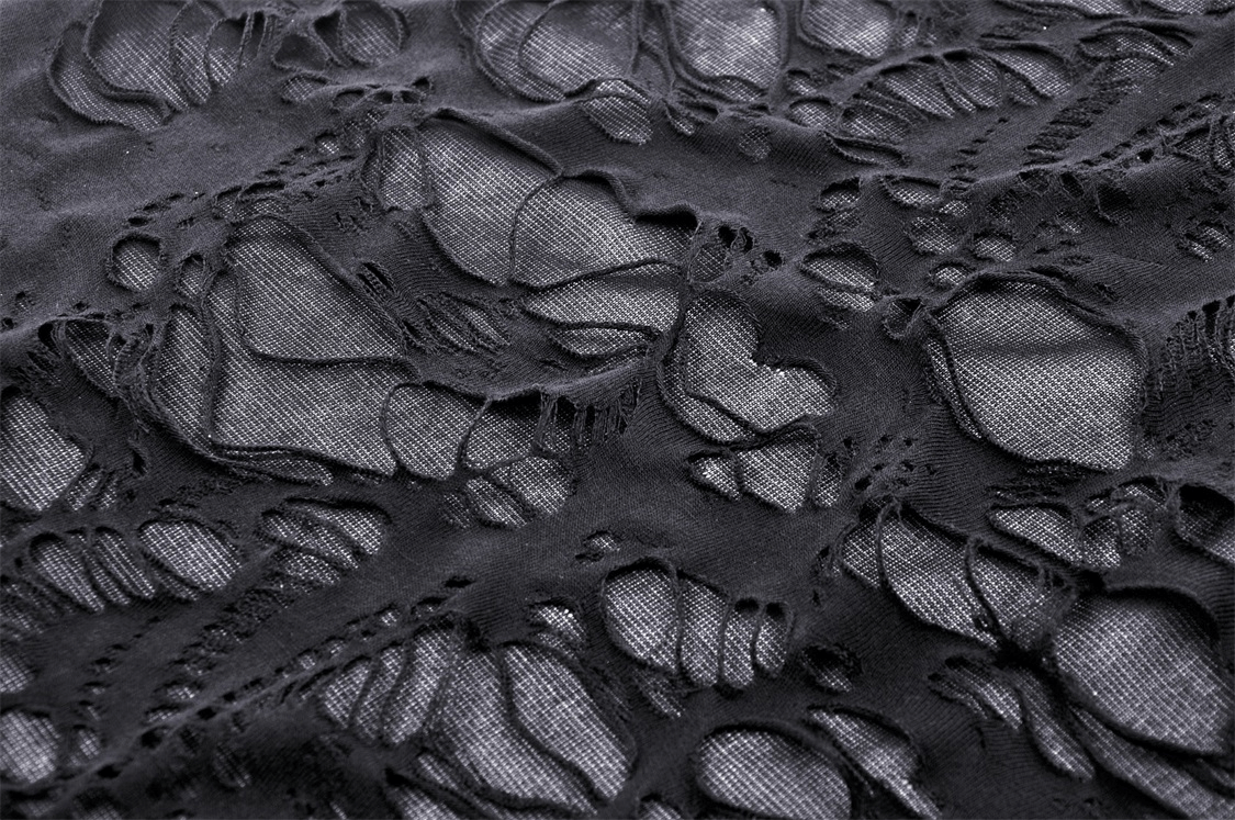 Close-up of textured black fabric showcasing intricate lace and shredded design, perfect for gothic fashion.