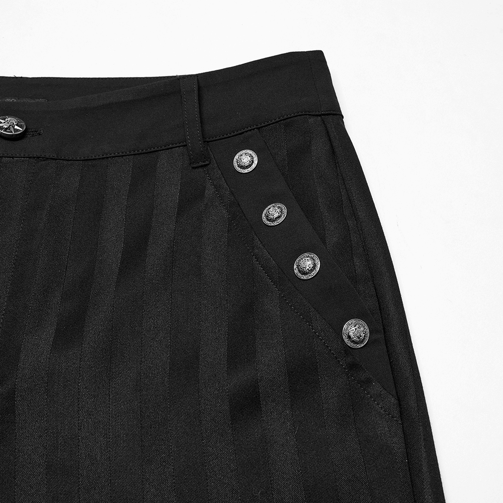 Close-up of black slim fit trousers featuring subtle stripes and ornate buckle details.