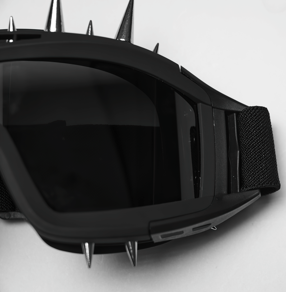 Black spiked punk goggles with adjustable strap and tinted lenses for a bold cyberpunk look.