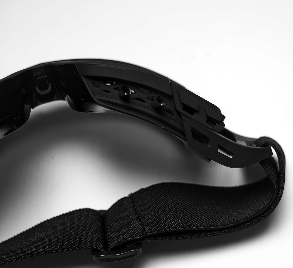 Close-up of black spiked punk goggles with adjustable elastic strap showcasing a futuristic design.