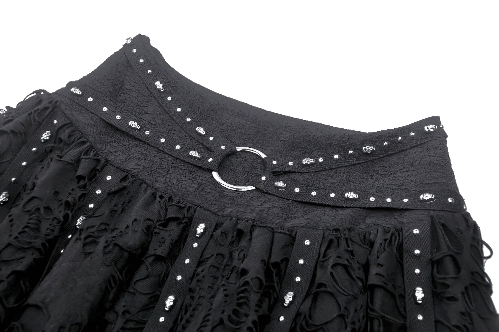 Close-up of a black studded gothic skirt featuring buckle detail and layered ruffles, showcasing dark elegance.