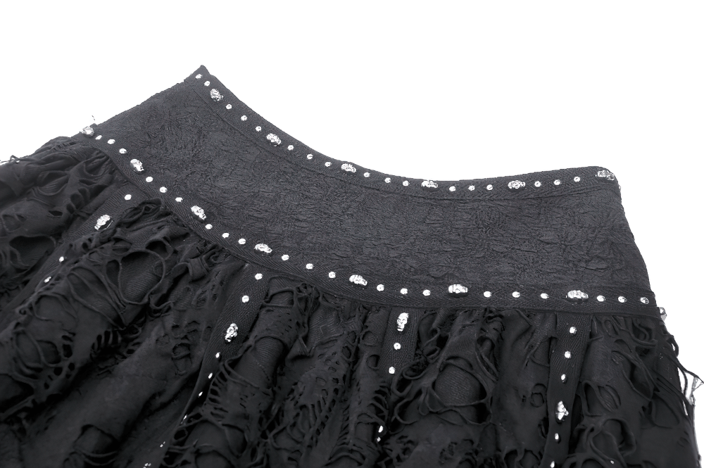 Black studded layered asymmetrical gothic skirt with intricate buckle details and dramatic texture.