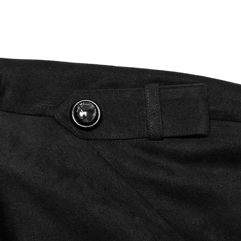 Close-up of the decorative buckle on the adjustable waist loop of a black suede gothic cape coat.