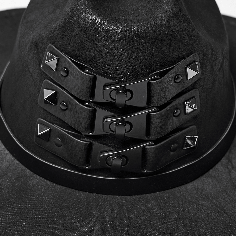 Close-up of black suede steampunk hat with triple buckle straps and metal rivets, showcasing stylish alternative fashion.