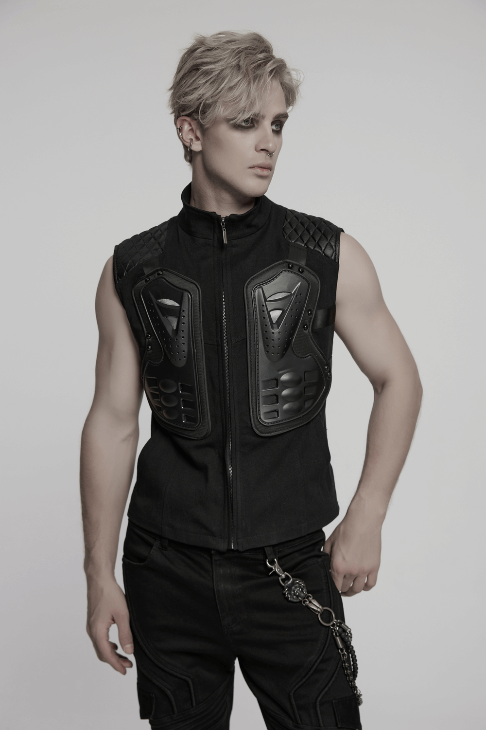 Black tactical vest with 3D rubber armor panels and glossy diamond patchwork for cyberpunk streetwear.