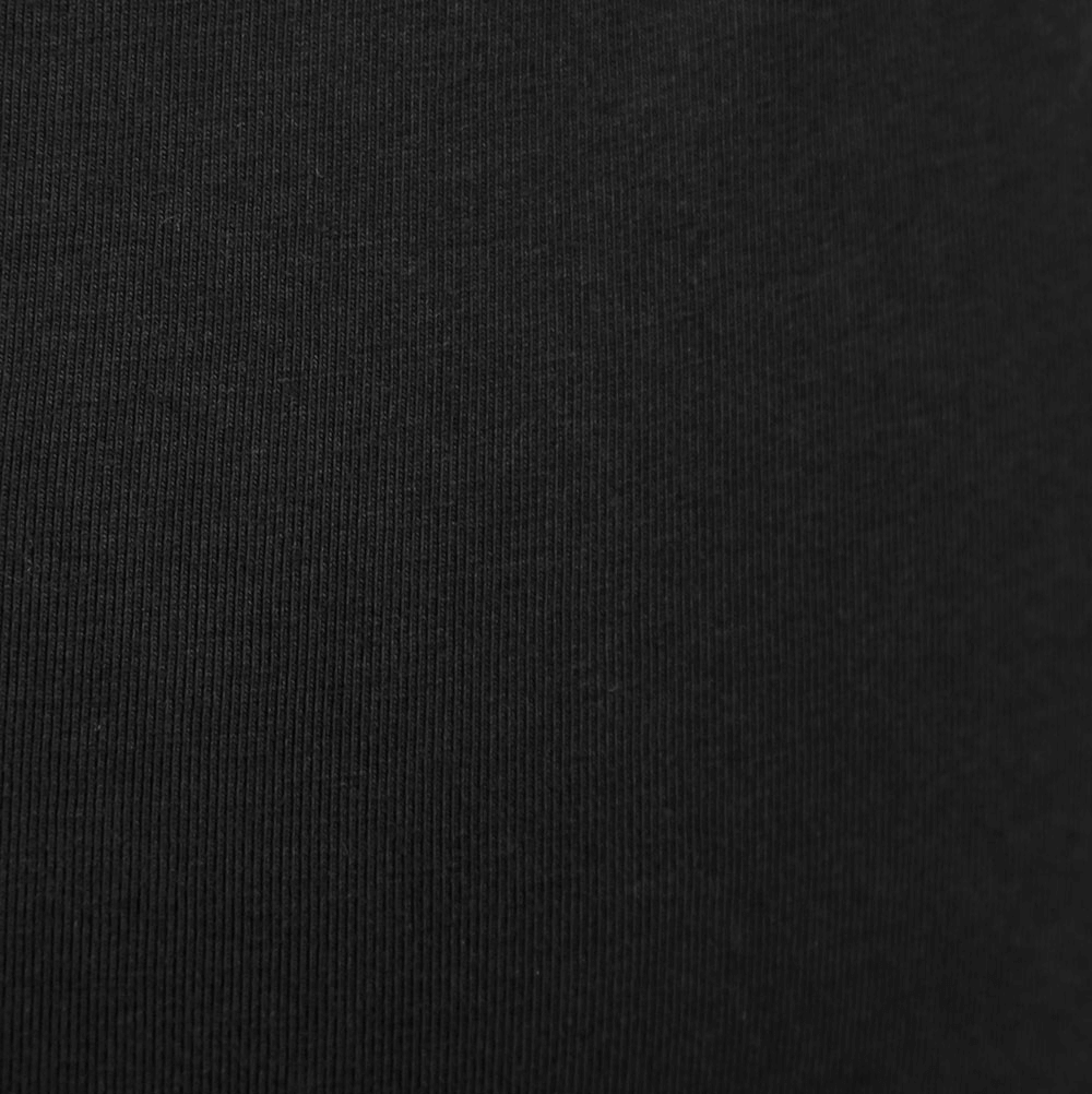 Close-up of soft, black tank top fabric showcasing its breathable texture and stylish design.