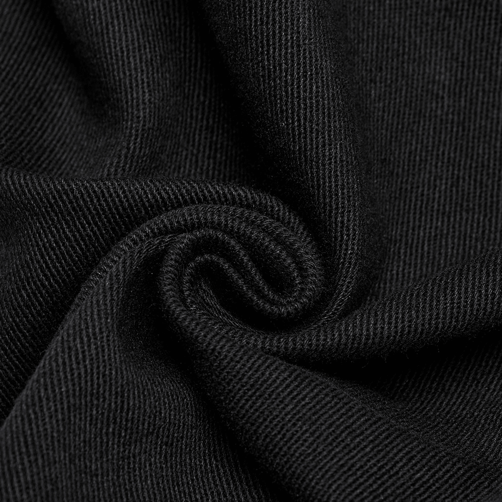 Close-up of soft black fabric, highlighting texture for techwear trousers with rubber patch details.