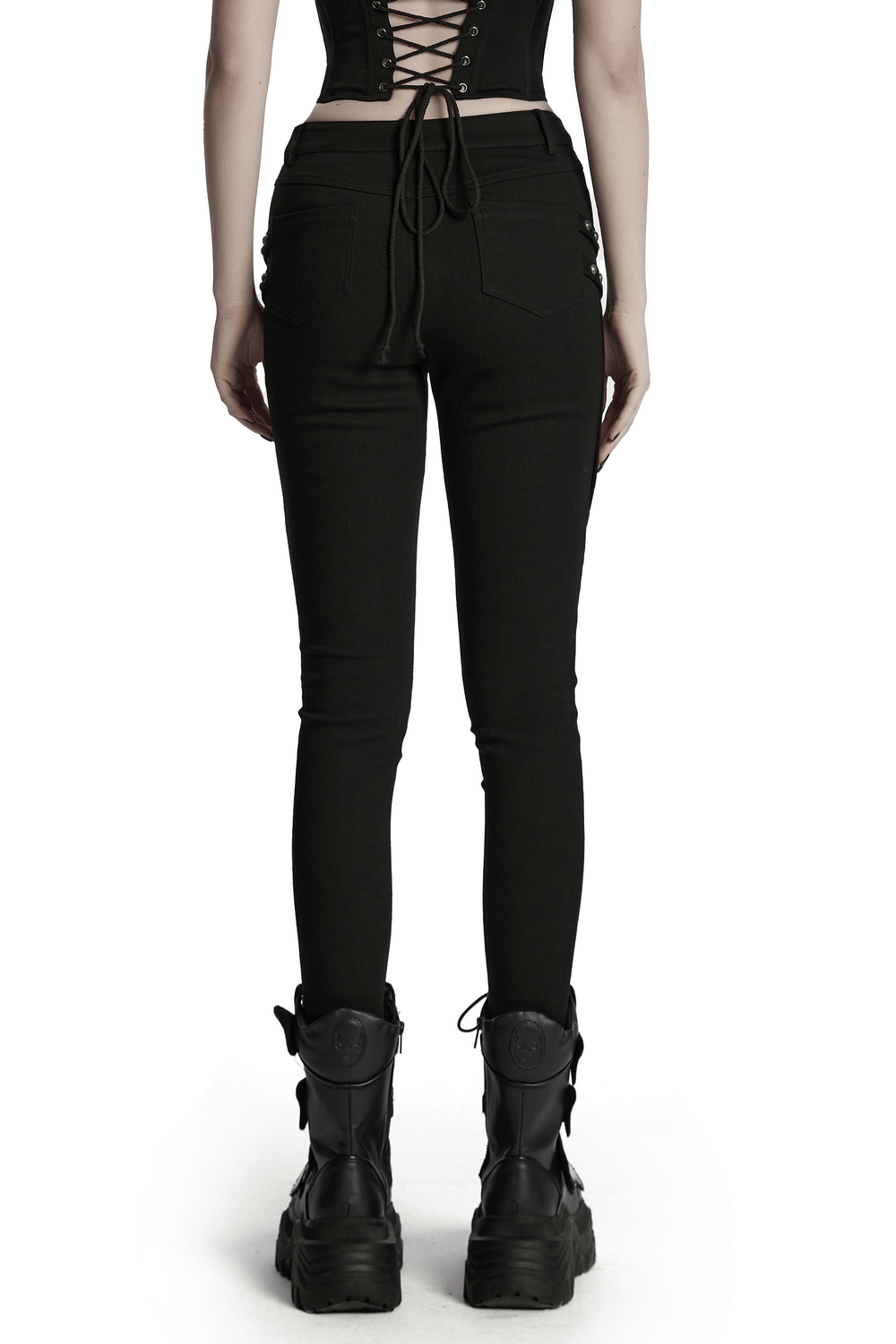 Back view of black techwear trousers featuring rubber patch details and stylish lace-up top.