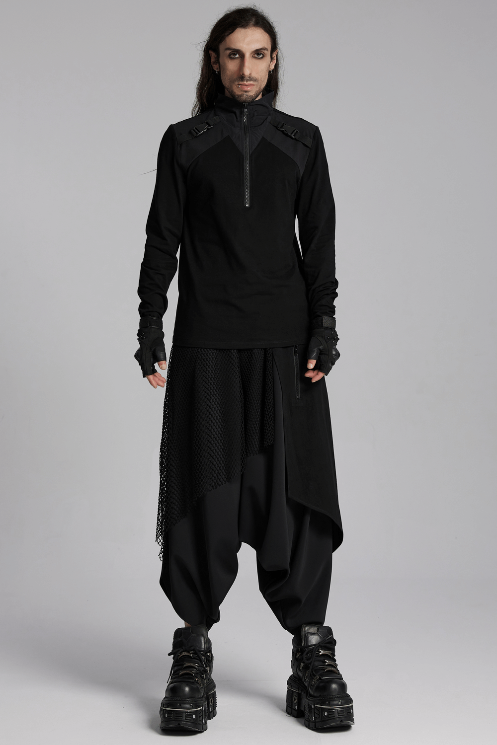 Black techwear zippered sweatshirt with shoulder buckles, paired with baggy pants, showcasing a bold cyberpunk style.