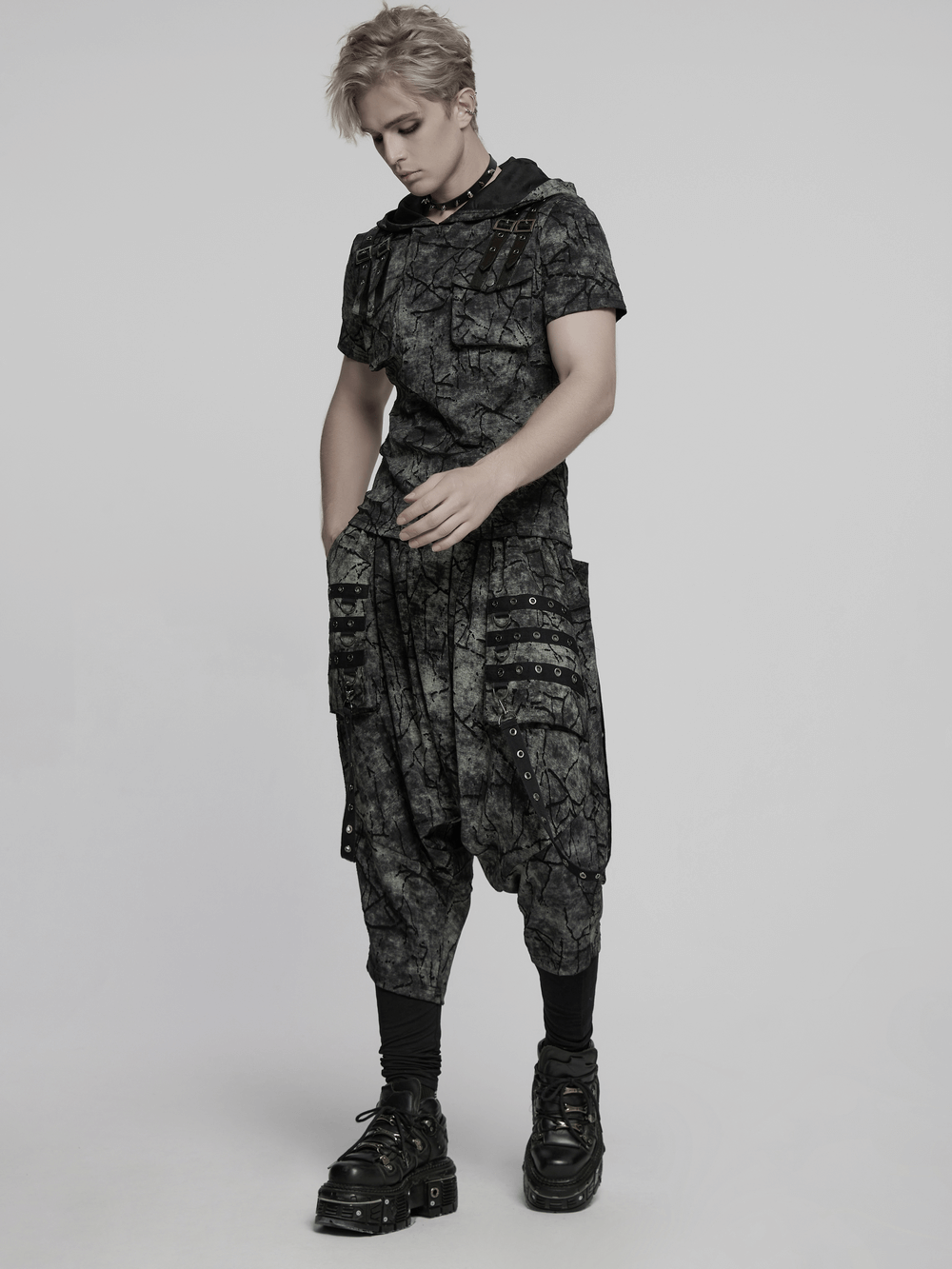 Black tie dye drop crotch pants with eyelet straps, showcasing a trendy and edgy look for modern fashion enthusiasts.