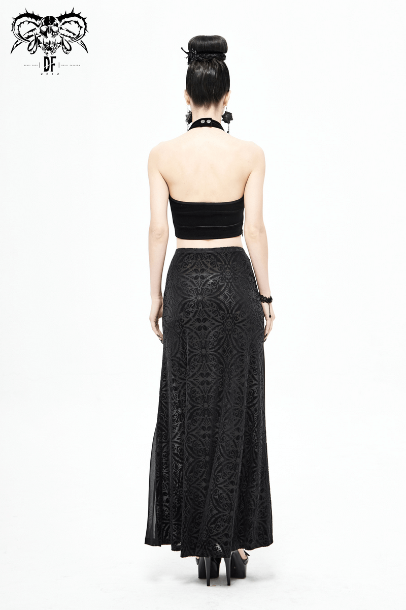 Back view of a woman wearing a high-waisted black transparent skirt and black crop top for gothic fashion.