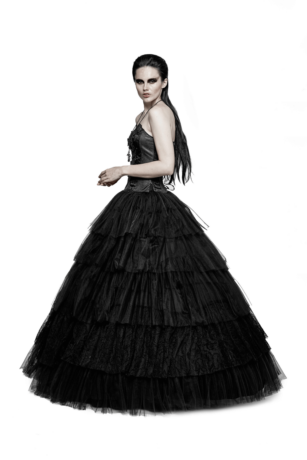 Elegant woman in black tulle long skirt with lace details, showcasing gothic wedding dress style.