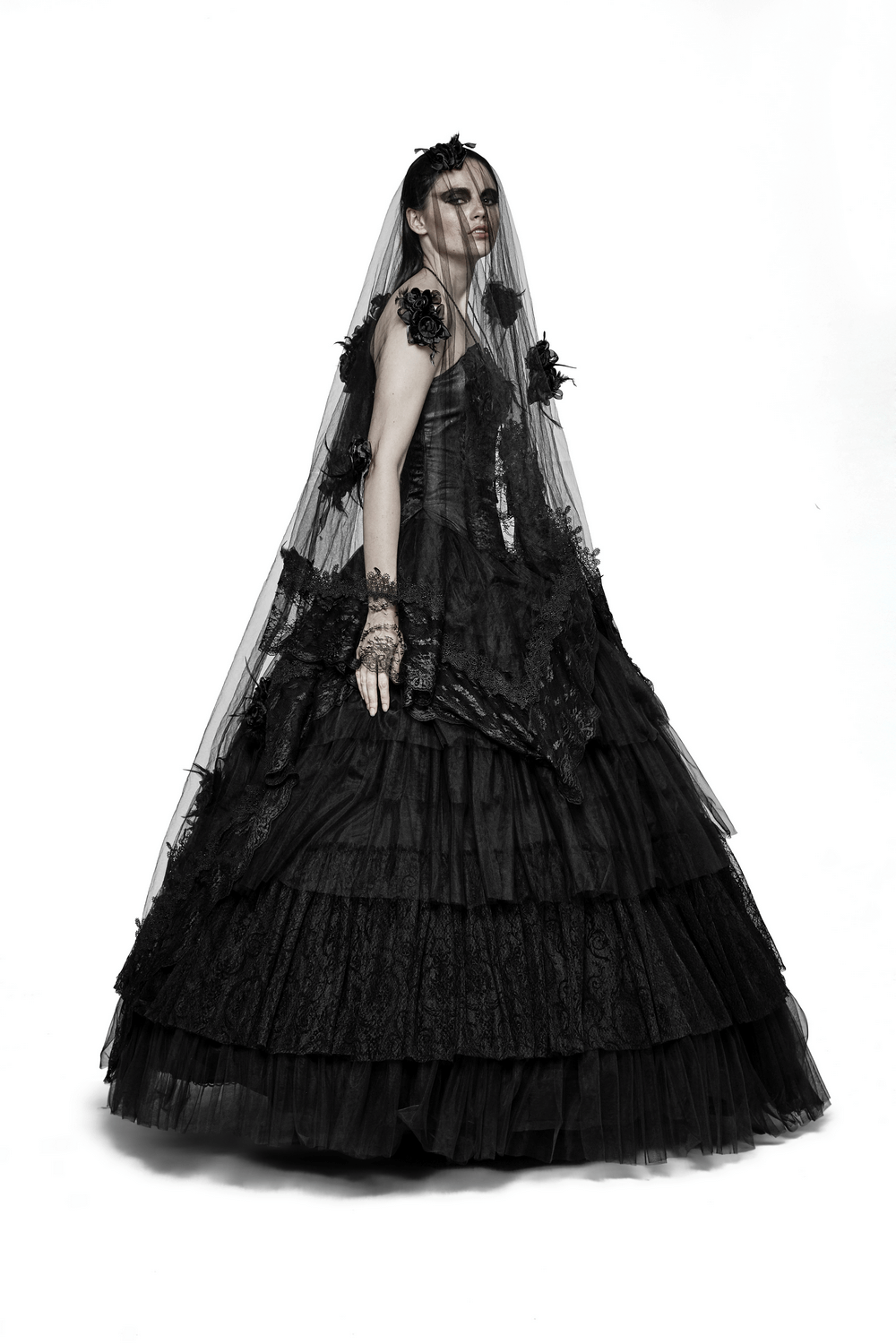 Gothic wedding dress with black tulle layers and lace details, featuring a dramatic veil and a romantic silhouette.