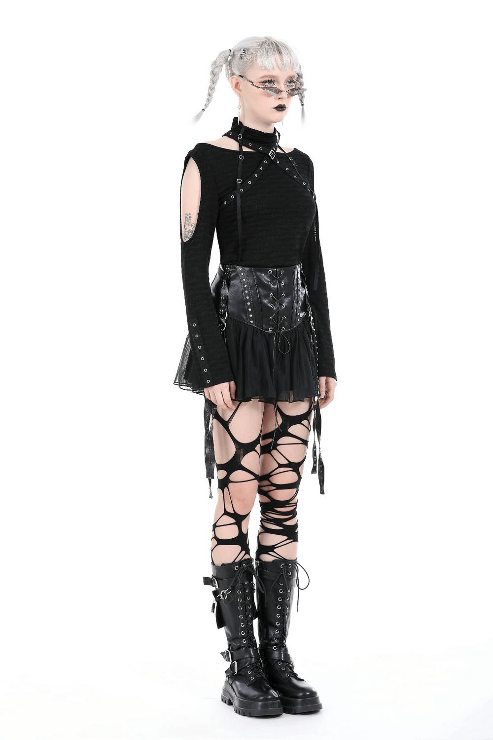 Edgy black outfit featuring a tulle skirt, lace-up corset, and thigh-high lace-up boots for a rockstar look.