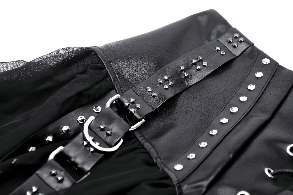 Close-up of the black tulle skirt with studded belt and lace-up corset detail, showcasing edgy design features.