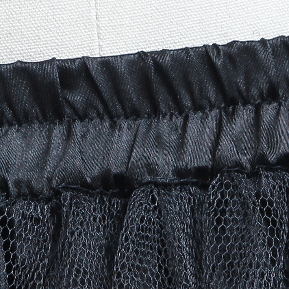 Close-up of black tulle skirt waistband with layered net mesh, perfect for punk and Lolita fashion styles.