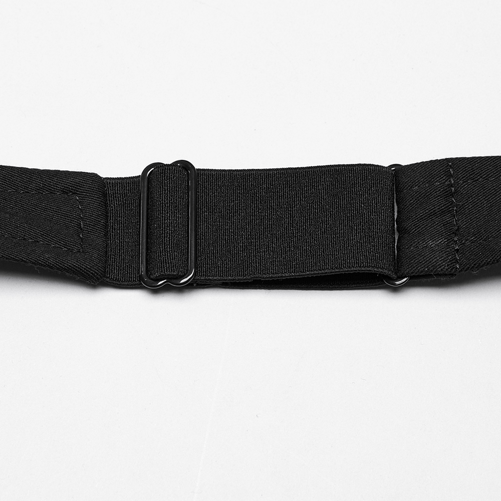 Close-up of a black twill strap with adjustable buckle for a punk harness dress.