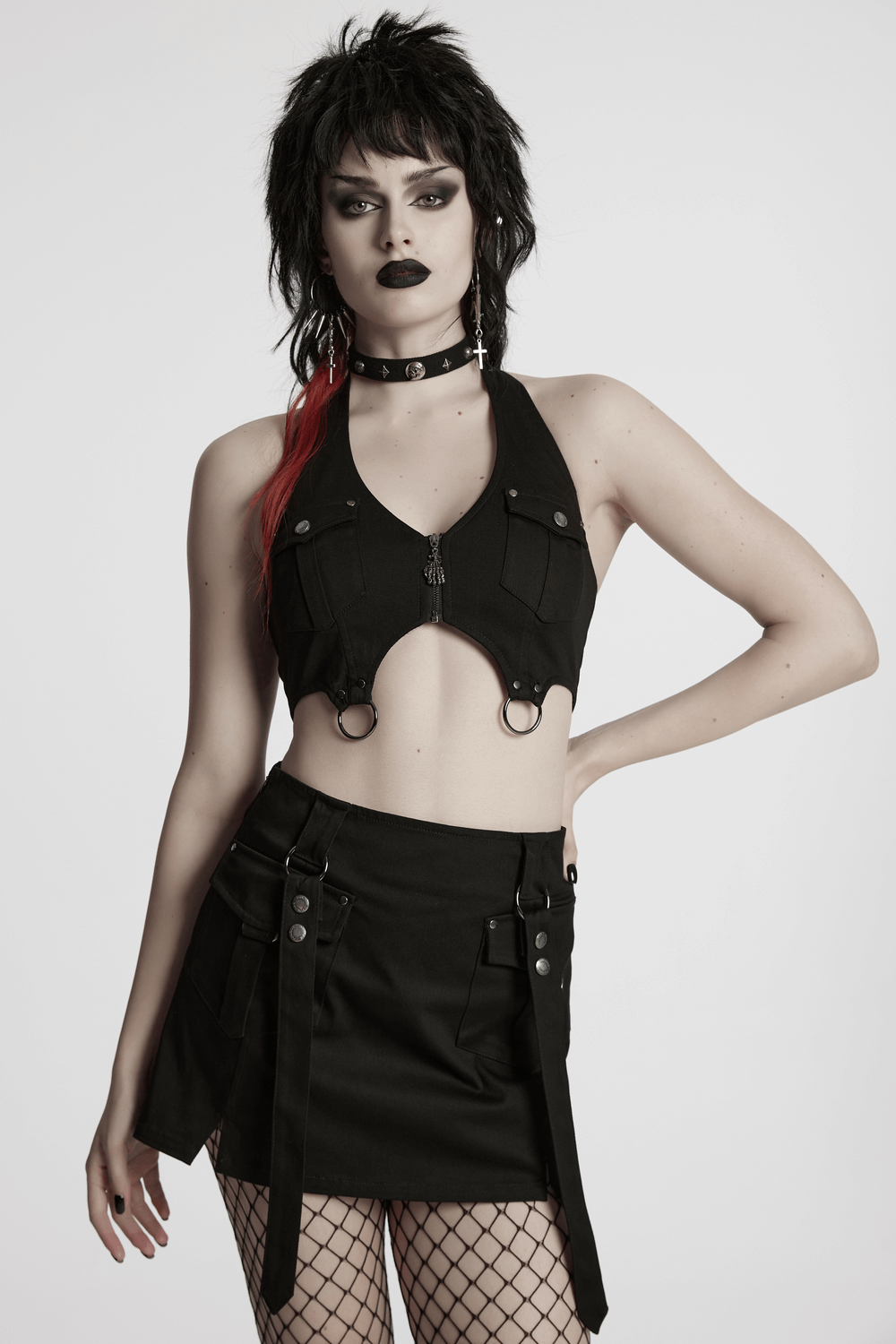 Model wearing a black twill punk harness dress with zipper, straps, and utility pockets, showcasing edgy style.