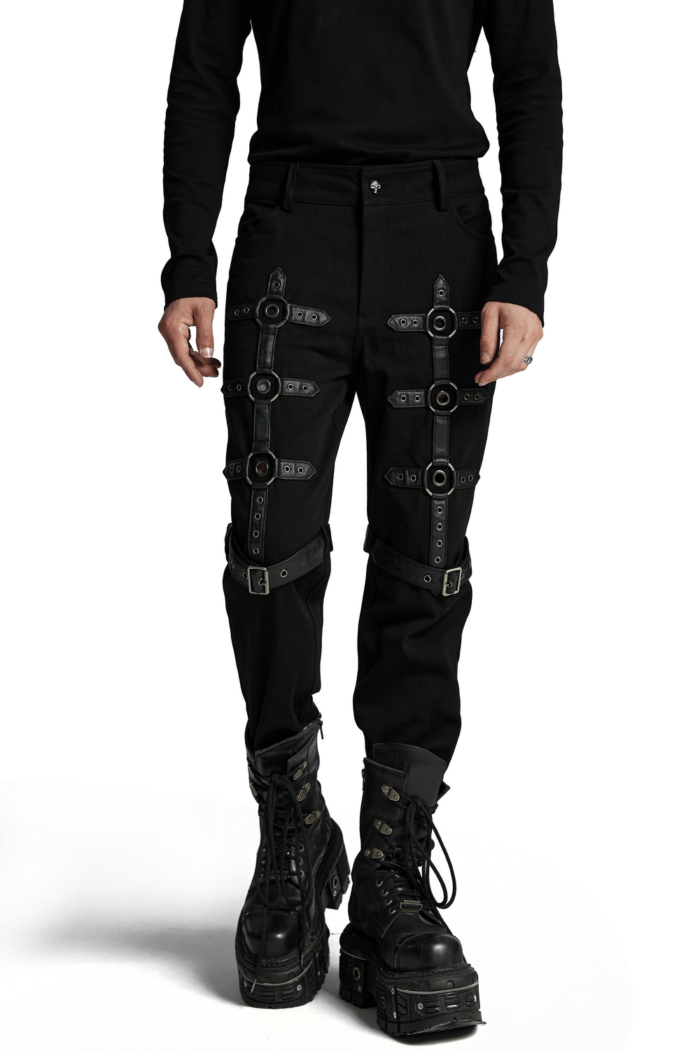 Black twill punk pants with metal rings and straps, paired with chunky black boots for an edgy look.