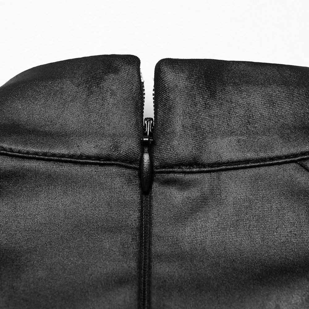 Close-up of the zipper detail on a black v-neck long sleeved top with shoulder pads, showcasing sleek design features.