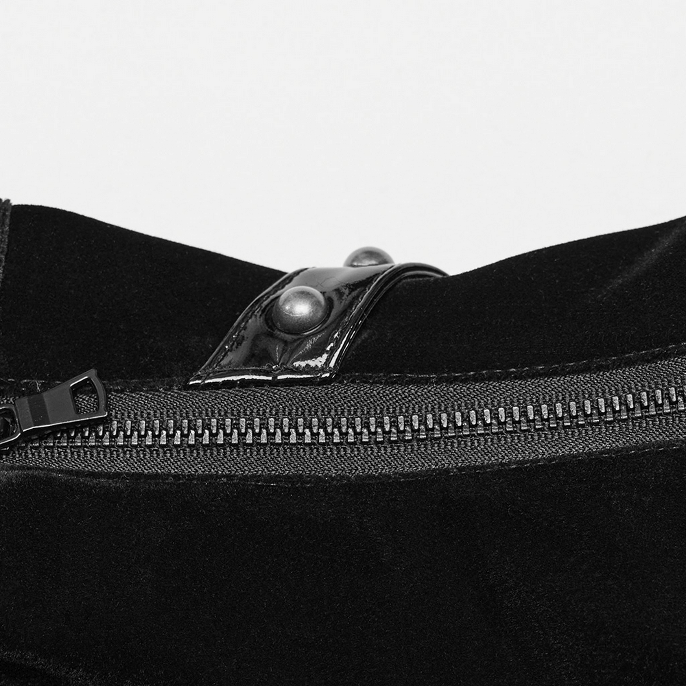Close-up of the zipper and rivet detailing on a black velvet and patent leather gothic corset belt.