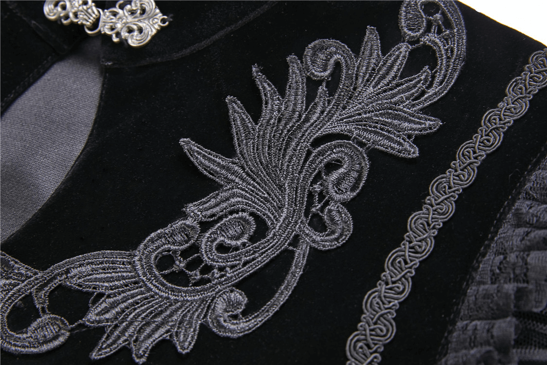 Close-up of embroidered lace collar on a black velvet capelet, showcasing intricate detailing and gothic elegance.