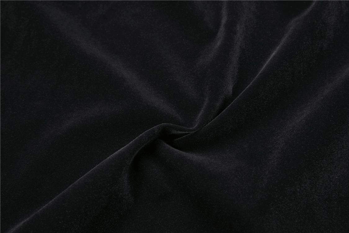 Close-up of luxurious black velvet fabric, showcasing soft texture ideal for Gothic Victorian capelet design.