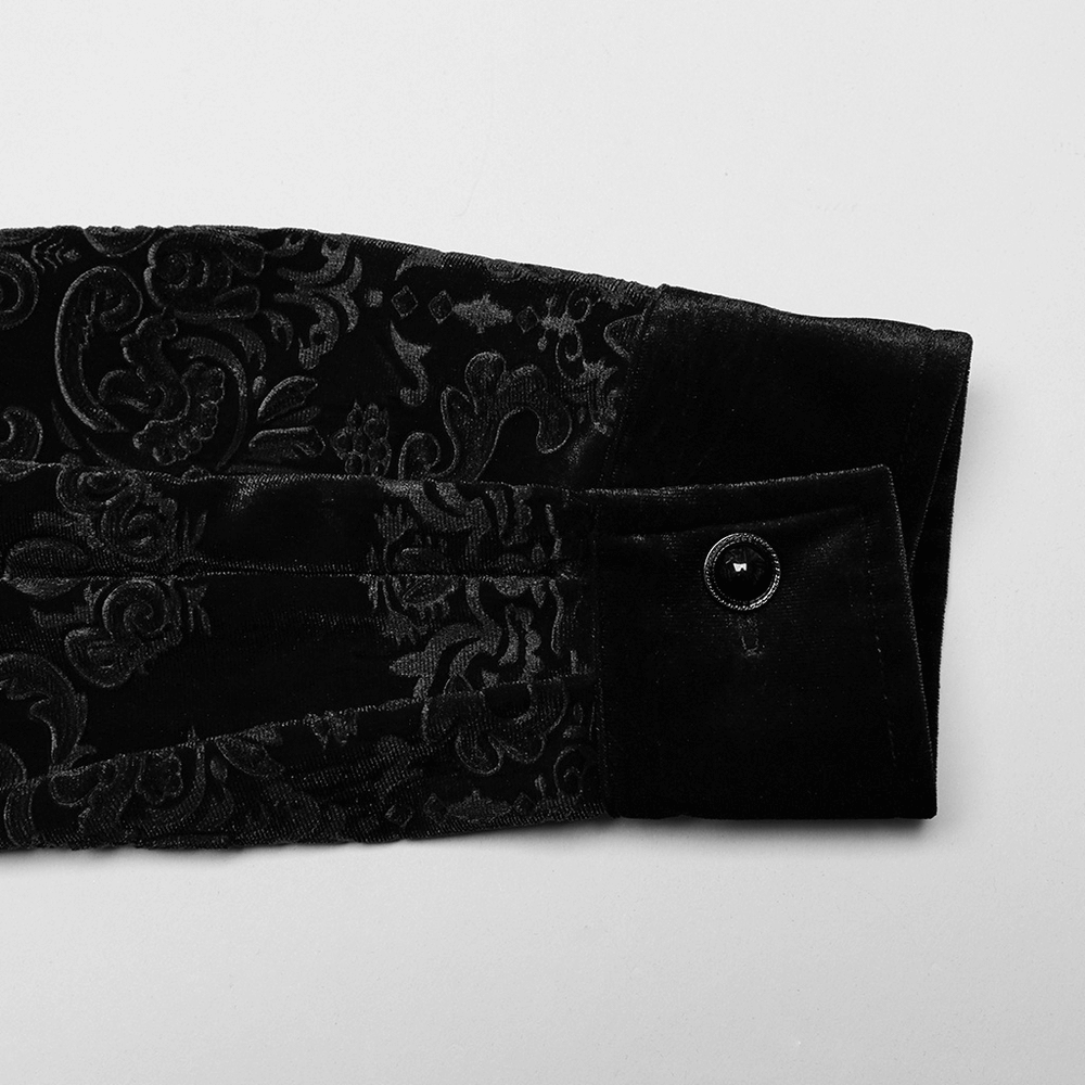Close-up of the embroidered floral cuff of a black velvet gothic shirt, showcasing luxurious texture and elegant detailing.